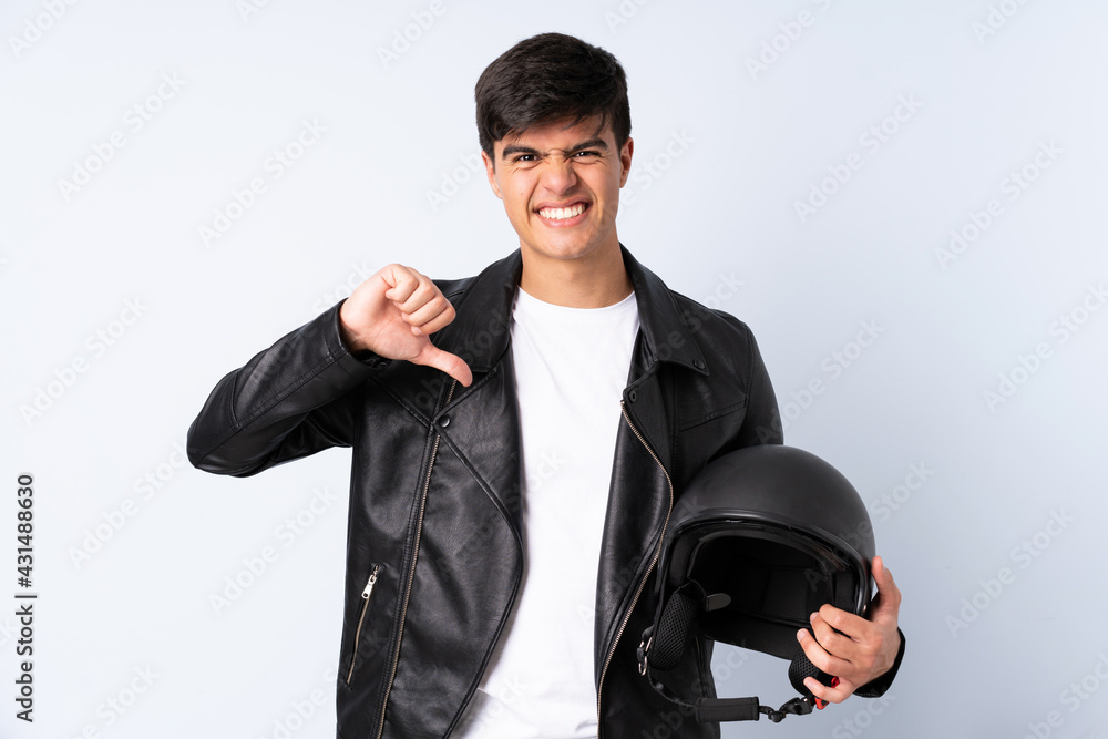 Man with a motorcycle helmet over isolated blue background proud and self-satisfied Man with a motorcycle helmet over isolated blue background proud and self-satisfied