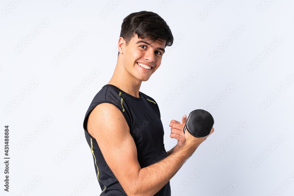 Sport man making weightlifting over isolated blue background and pointing it