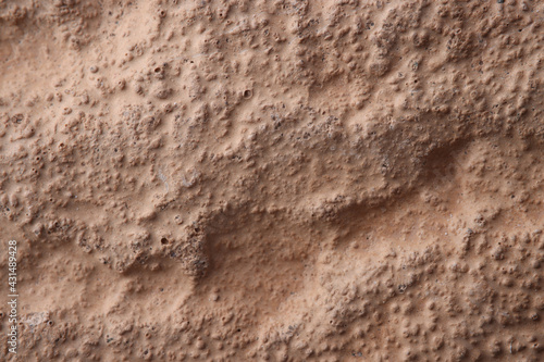 Closeup of brown uneven wall painted with paint background