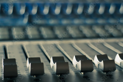 close up of sound mixer board equipment equalizer audio improve levels quality recording
