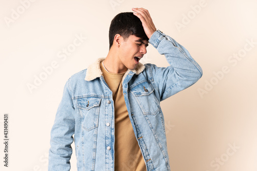 Handsome man over isolated beige background has realized something and intending the solution