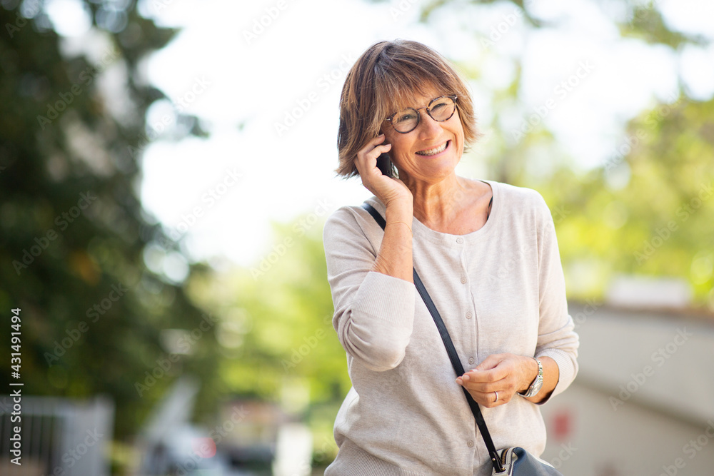 older woman talking with cellphone outdoors older woman talking with cellphone outdoors