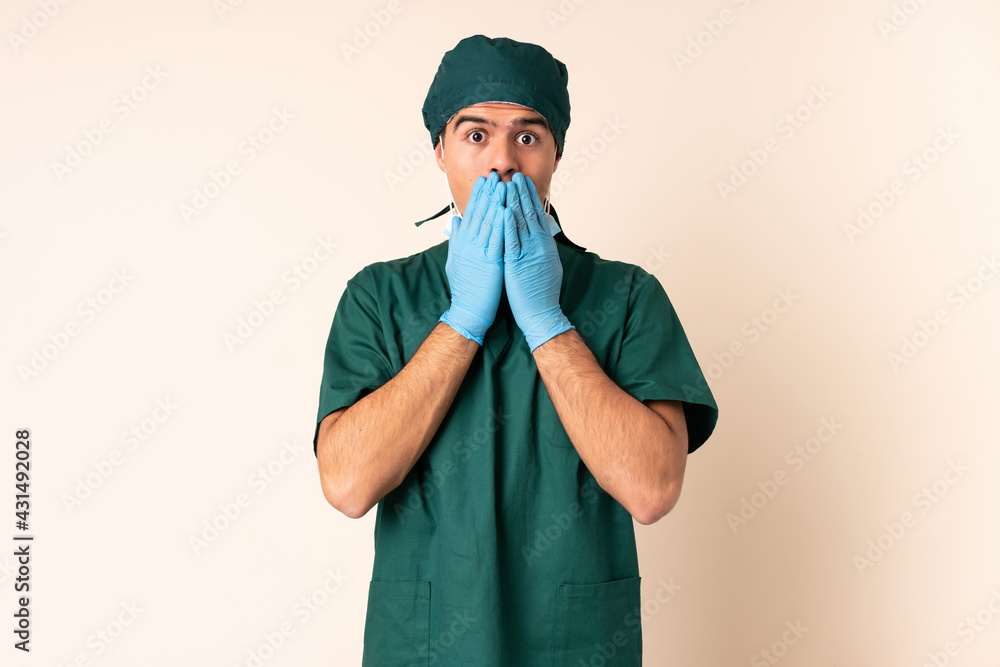 Surgeon man in blue uniform over isolated background with surprise facial expression Surgeon man in blue uniform over isolated background with surprise facial expression