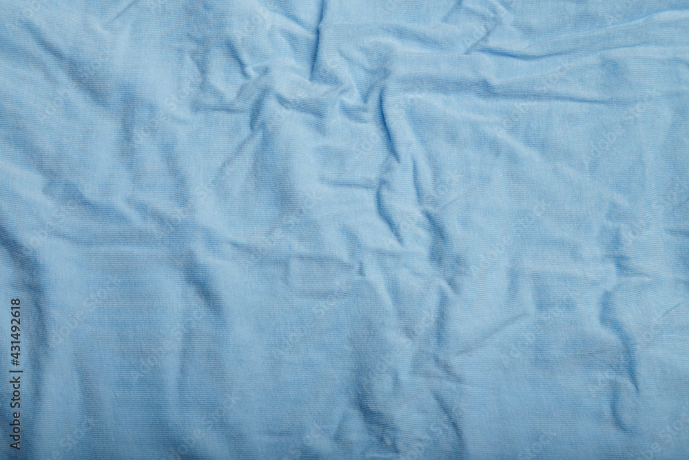 Texture of blue cotton wrinkled fabric, background or backdrop. Clothing, sewing, gressmaking, haberdashery. Copy space. Texture of blue cotton wrinkled fabric, background or backdrop. Clothing, sewing, gressmaking, haberdashery. Copy space.