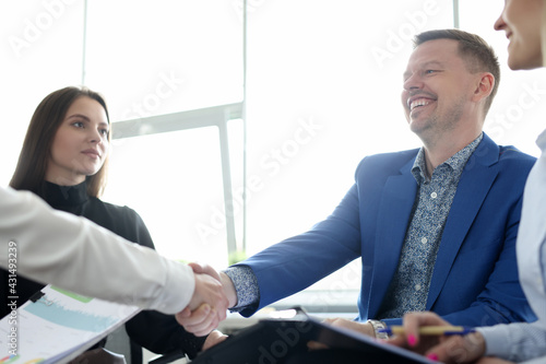 Schilderij op canvas Man shaking hands with colleague at business meeting in office