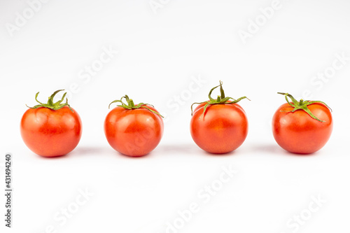 Four tomatoes isolated on a white background.
