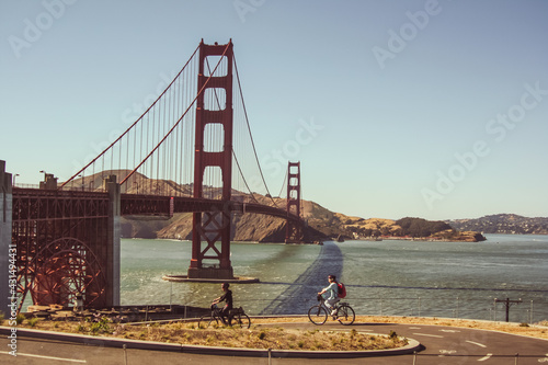 Couple riding bikes the Golden Gate Bridge in San Francisco, United States of America aka USA