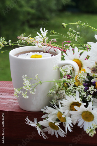 A cup with floral natural chamomile tea