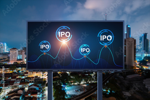 IPO icon hologram on road billboard over night panorama city view of Kuala Lumpur. KL is the hub of initial public offering in Malaysia, Asia. The concept of exceeding business opportunities.