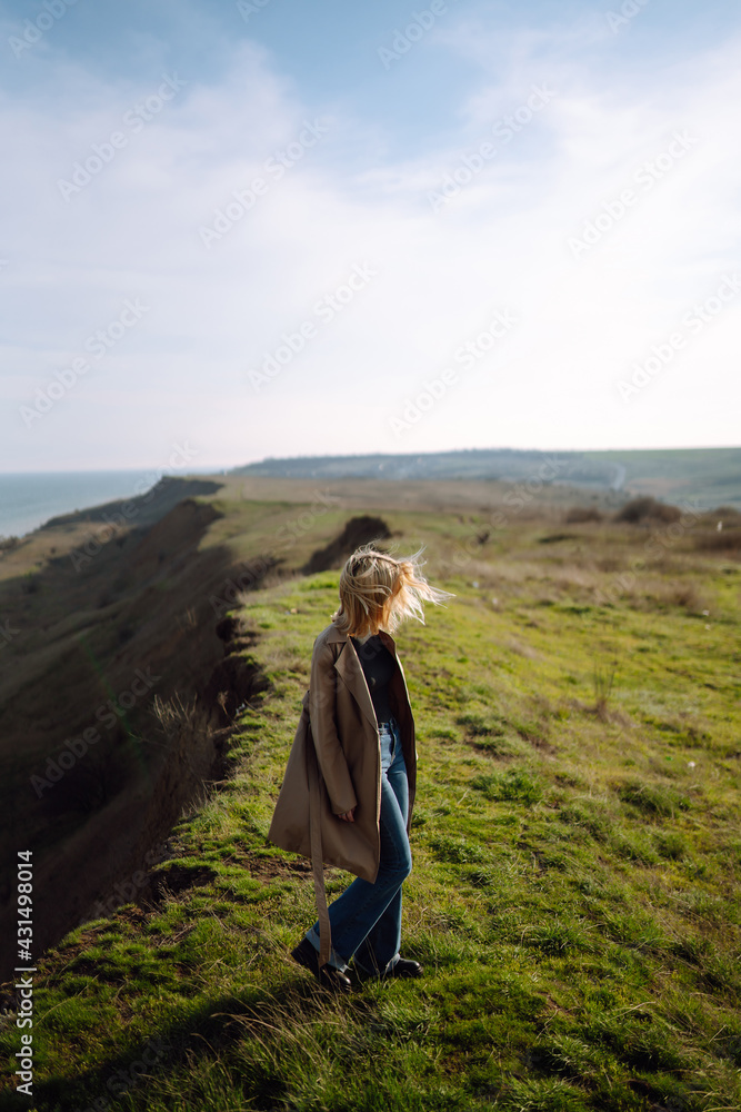 Portrait of beautiful young woman enjoys a spring sunny day. People, lifestyle, travel, nature and vacations concept.