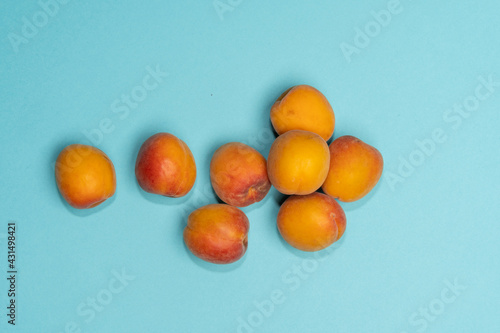 Pile of small, fresh, ripe, juicy, peaches on a colourful background, stock picture.