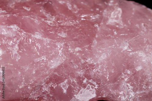 Macro mineral stone Pink quartz on black background