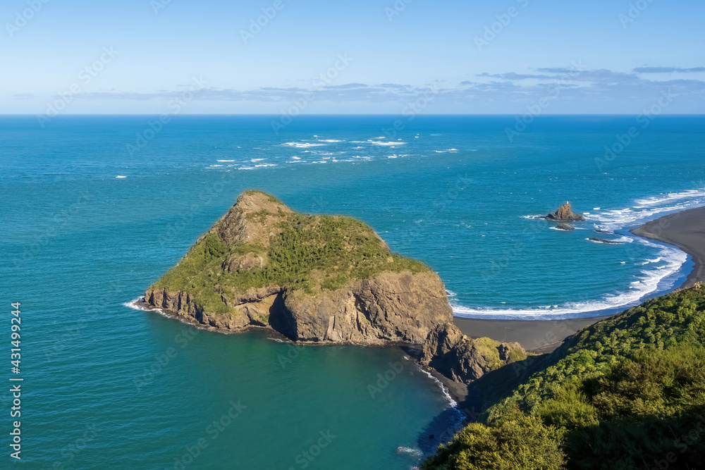 Paratutae Island and Ninepin Rock at Whatipu beach, Auckland, New Zealand