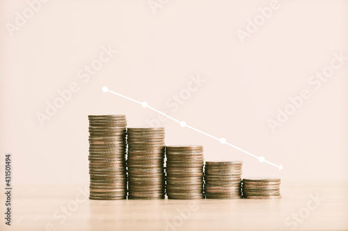 Thai coins are lined up on the table shown in the form of down graph vintage tone , business and financial concept photo