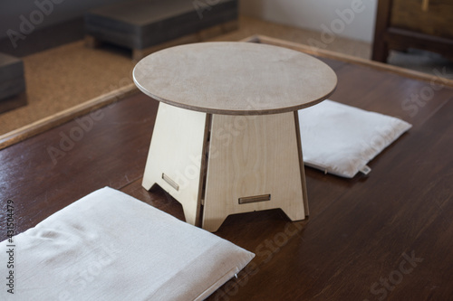 Korean traditional style wooden tea table and white cushion. photo