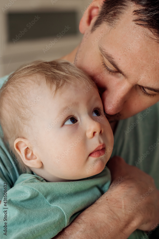 A happy father hugs and kisses his baby son.Time together.A family concept.Father's Day concept.Paternal care.Newborn care.Close up,selective focus. A happy father hugs and kisses his baby son.Time together.A family concept.Father's Day concept.Paternal care.Newborn care.Close up,selective focus.