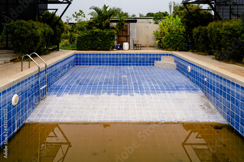 Dilapidated old building with ruined swimming pool.