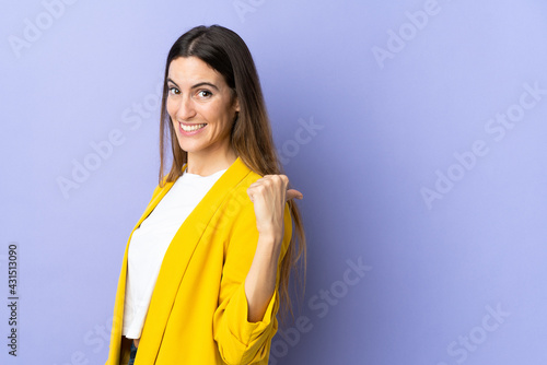 Young caucasian woman over isolated background pointing to the side to present a product