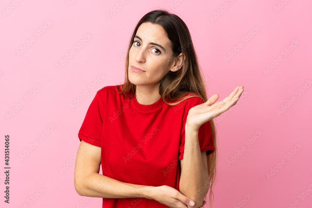 Young caucasian woman isolated on pink background having doubts Young caucasian woman isolated on pink background having doubts