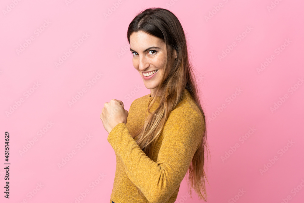 Young caucasian woman isolated on pink background celebrating a victory Young caucasian woman isolated on pink background celebrating a victory