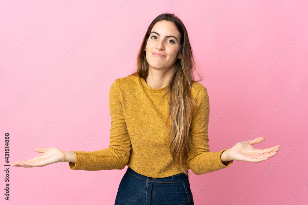 Young caucasian woman isolated on pink background having doubts Young caucasian woman isolated on pink background having doubts