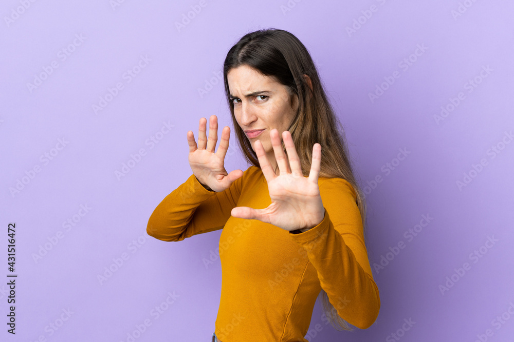 Young caucasian woman over isolated background nervous stretching hands to the front Young caucasian woman over isolated background nervous stretching hands to the front