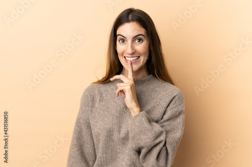 Young caucasian woman over isolated background showing a sign of silence gesture putting finger in mouth