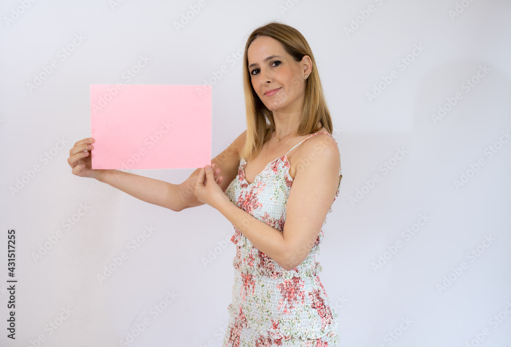 Young pretty woman cheerful and motivated, showing an empty poster where you can show a message, communication concept Young pretty woman cheerful and motivated, showing an empty poster where you can show a message, communication concept