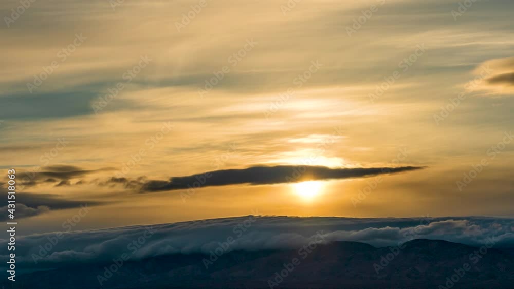 The golden sky and cloudscape provides a scenic view in the fast moving time lapse at sunset The golden sky and cloudscape provides a scenic view in the fast moving time lapse at sunset