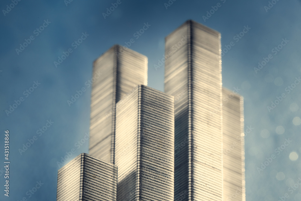City scape made of staples on blue background with bokeh. City scape made of staples on blue background with bokeh.