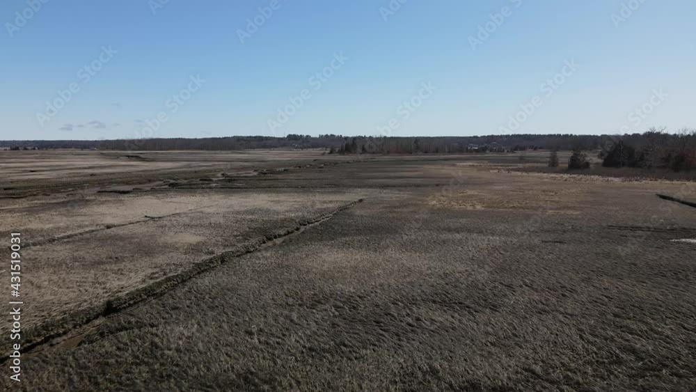 Aerial flyover of a tidal salt marsh during a sunny day with bright blue sky in Scituate,Massachusetts. USA Drone Aerial flyover of a tidal salt marsh during a sunny day with bright blue sky in Scituate,Massachusetts. USA Drone