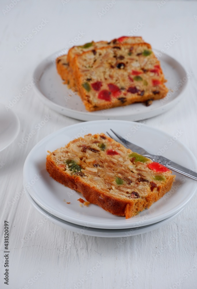 Traditional fruit cake pudding with dried fruits on white background Traditional fruit cake pudding with dried fruits on white background