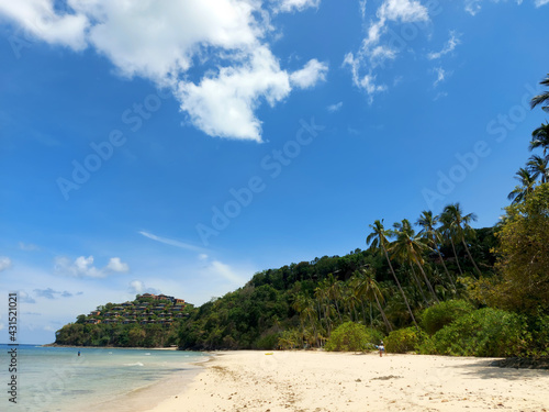 Tropical beach and luxury real estate on the island in the background