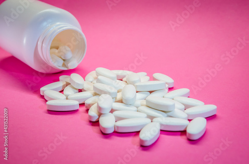 Pharmacy and bottle isolated on a pink background. Medical pills. Medicine and healthy.