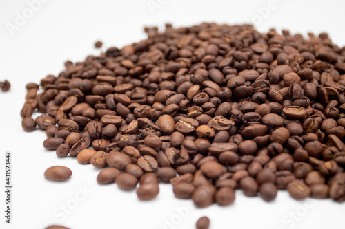 A bunch of coffee beans. Coffee beans isolated on white background. Fresh roasted coffee beans.