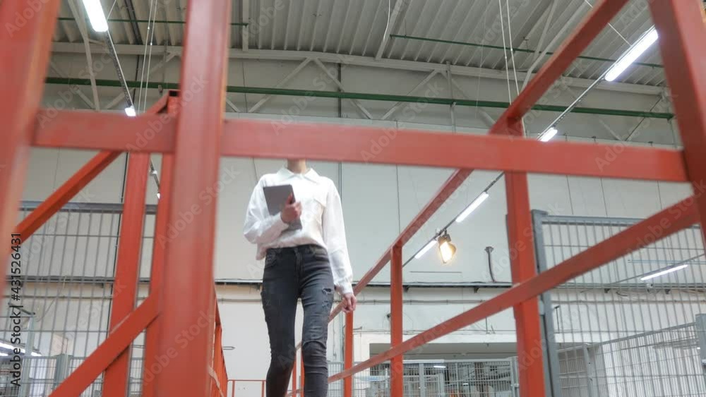 Business woman in Industrial Carpentry factory - production of wooden boards with modern machines. Modern robotic factory indoors. Woodworking production. Business woman in Industrial Carpentry factory - production of wooden boards with modern machines. Modern robotic factory indoors. Woodworking production.