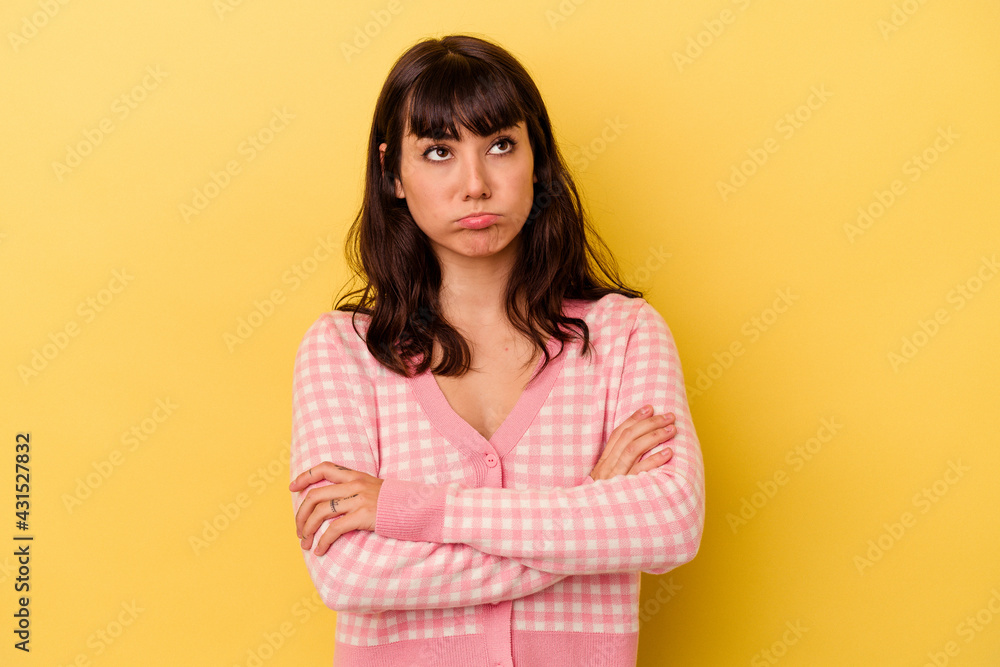 Fototapeta premium Young caucasian woman isolated on yellow background tired of a repetitive task.