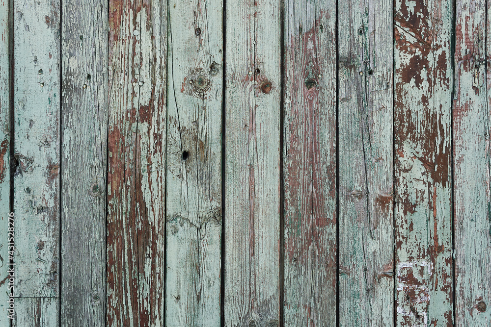 Wooden aged paint background. Dark turquoise paint has cracked from time to time on solid wood planks that are stacked vertically. Wooden aged paint background. Dark turquoise paint has cracked from time to time on solid wood planks that are stacked vertically.