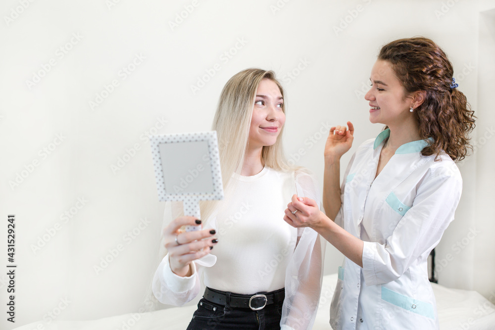Girl consultations with a cosmetologist standing in a beauty salon Girl consultations with a cosmetologist standing in a beauty salon
