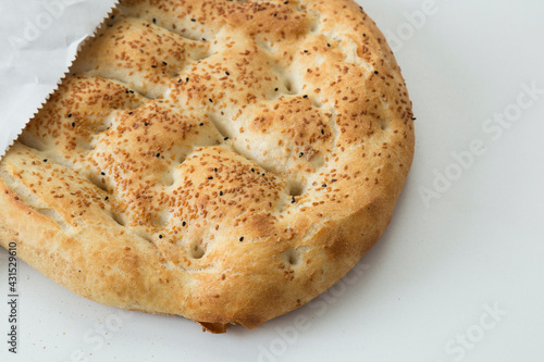 Turkish Ramadan Pide  bread on the whit background. © Fertas