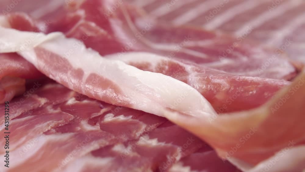 A piece of cured delicious jamon. Macro. Meat fat is a traditionally prepared Spanish delicacy. Dolly shot A piece of cured delicious jamon. Macro. Meat fat is a traditionally prepared Spanish delicacy. Dolly shot