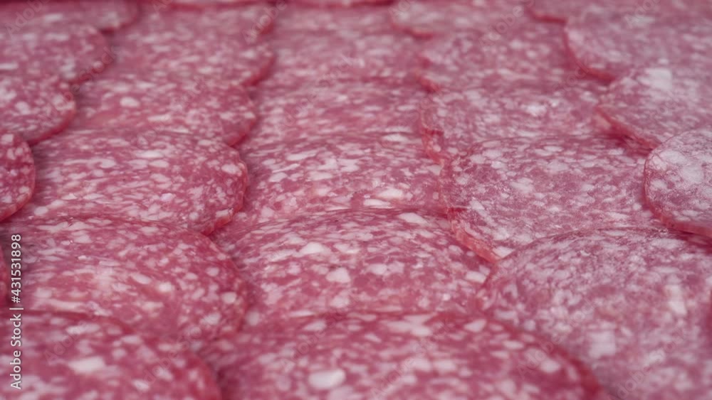 Freshly sliced meat gourmet salami sausage, stacked in rows. Macro. Dolly Shot Freshly sliced meat gourmet salami sausage, stacked in rows. Macro. Dolly Shot