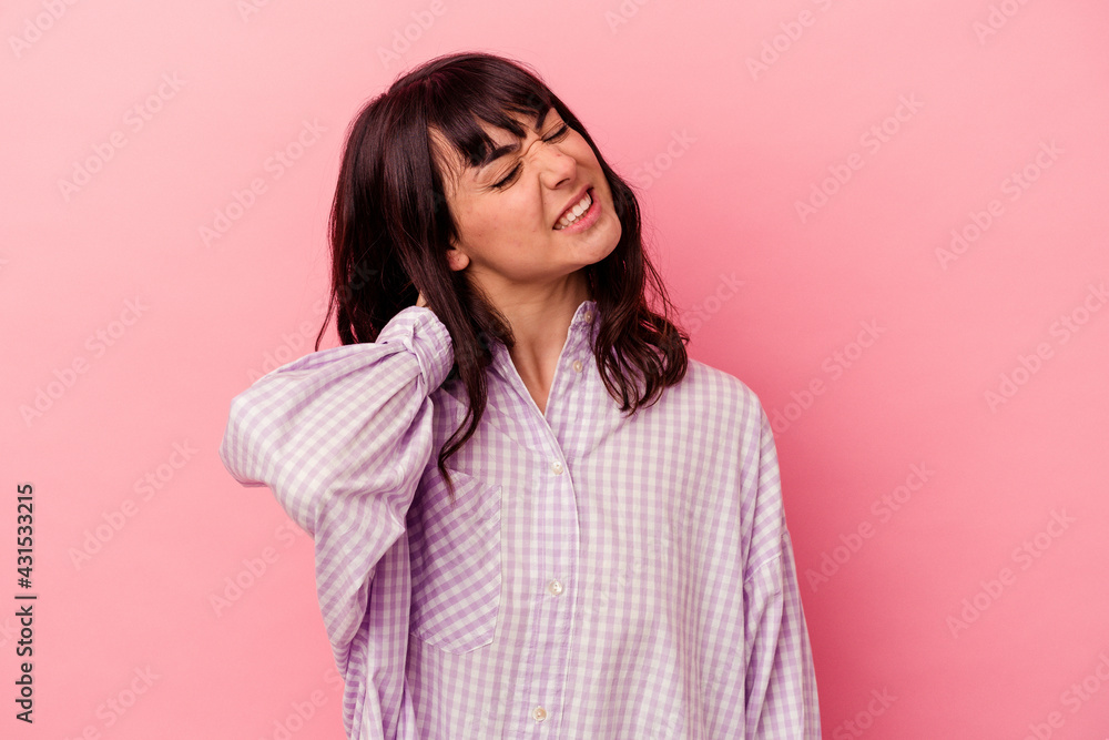 Young caucasian woman isolated on pink background having a neck pain due to stress, massaging and touching it with hand. Young caucasian woman isolated on pink background having a neck pain due to stress, massaging and touching it with hand.