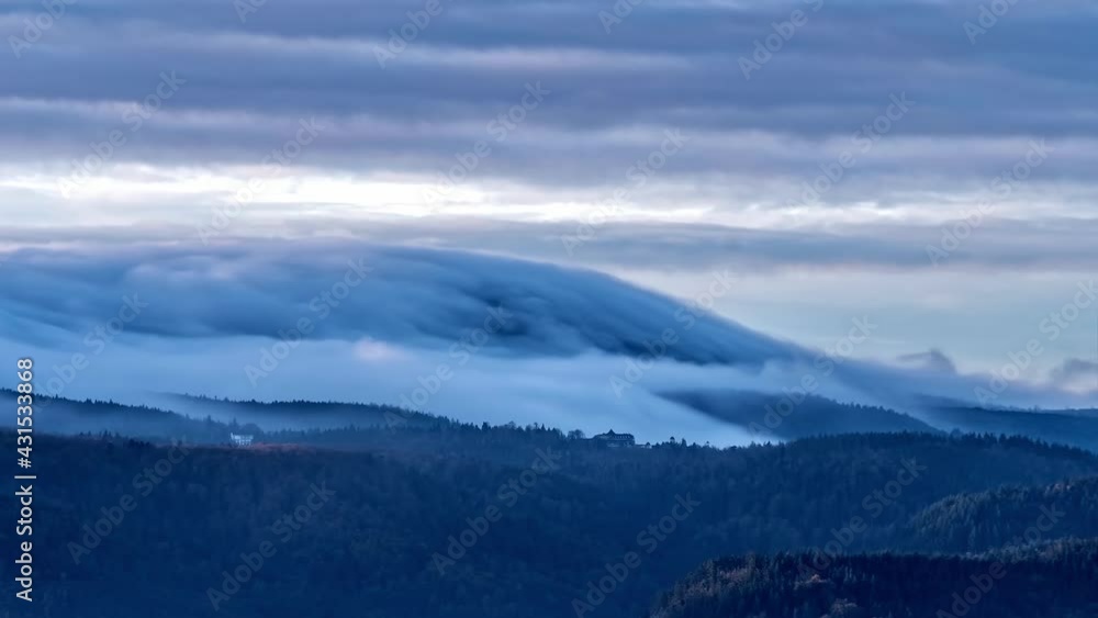 Time-lapse shot of moving clouds in the sky and on the top of mountains in Baden-Baden, Germany Time-lapse shot of moving clouds in the sky and on the top of mountains in Baden-Baden, Germany