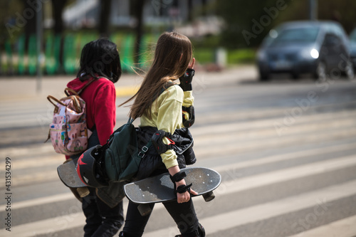 Teenagers with skateboards on crosswalk