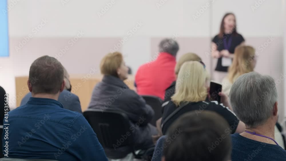 Business speaker doing presentation to audience Business speaker doing presentation to audience