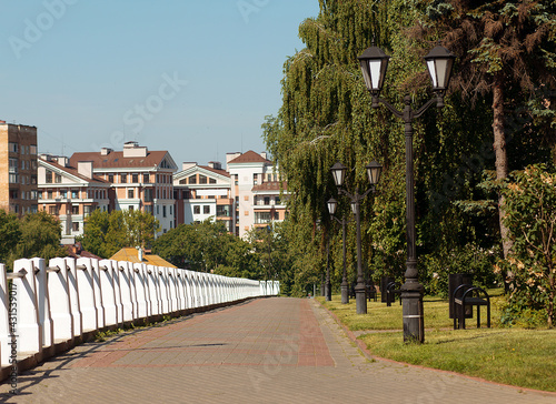 Green embankment of the city street. Alley. © pushann