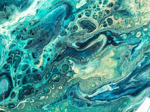Fluid abstract acrylic painting. Mixed gold, green, blue paint. Epoxy resin art, pour painting, marble texture 