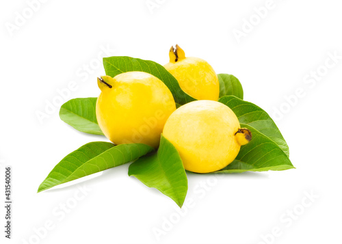 Ripe yellow guava fruit with a sliced piece with their leaves isolated on white background