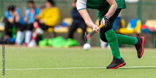 Photography Hockey player woman with ball in attack playing field hockey game